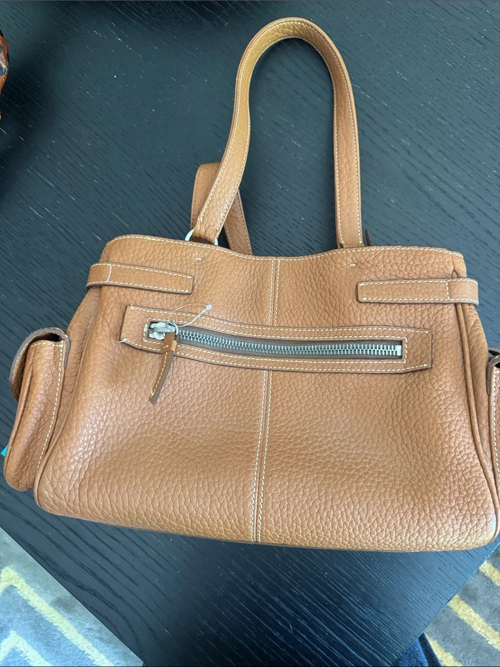Dooney & Bourke tan pebbled leather side pockets belted satchel bag.